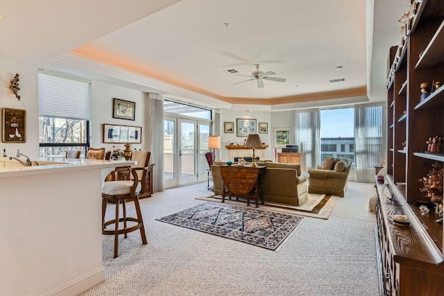 1115 W 7th St W Unit 202, Austin, TX 78703 - living area with a raised ceiling, light colored carpet, crown molding, and ceiling fan