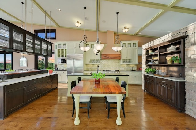 8700 Crest View Rd, Austin, TX 78737 - kitchen featuring built in appliances, an island with sink, dark brown cabinets, open shelves, and lofted ceiling
