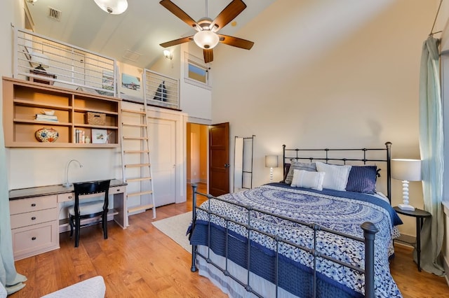 8700 Crest View Rd, Austin, TX 78737 - bedroom with high vaulted ceiling, light wood-type flooring, and a desk