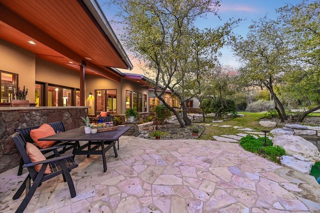 8700 Crest View Rd, Austin, TX 78737 - patio terrace at dusk featuring a patio and outdoor dining area