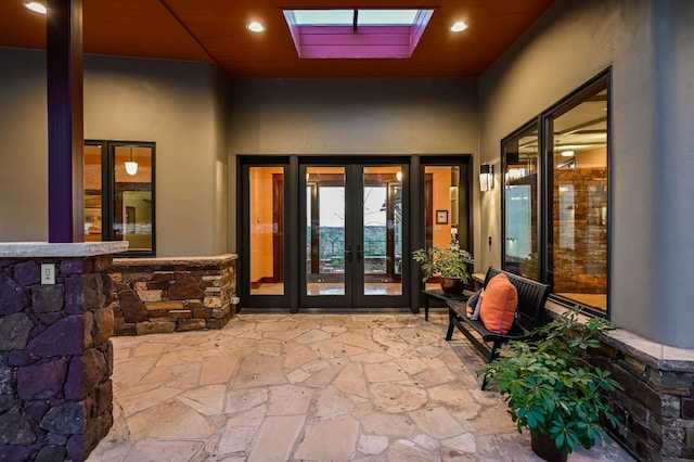 8700 Crest View Rd, Austin, TX 78737 - entrance to property featuring french doors, stucco siding, a patio area, and stone siding