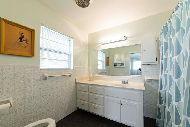 658 Golden Beach Dr, Buchanan Dam, TX 78609 - bathroom featuring a wainscoted wall, a shower with curtain, vanity, and tile walls