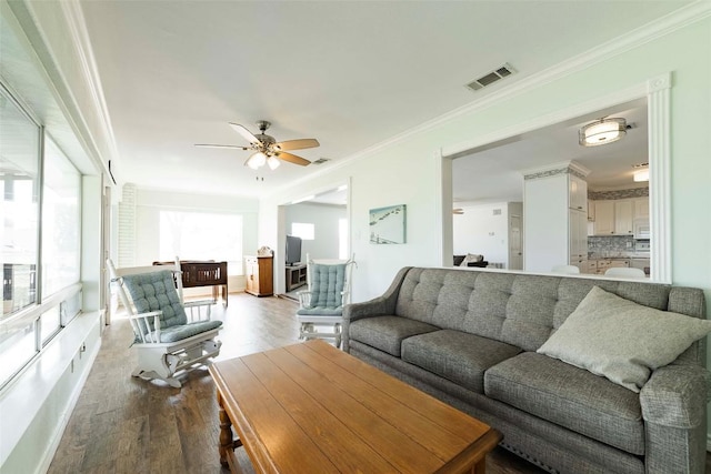 658 Golden Beach Dr, Buchanan Dam, TX 78609 - living room featuring visible vents, crown molding, wood finished floors, and ceiling fan