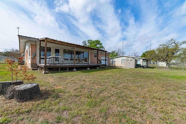 658 Golden Beach Dr, Buchanan Dam, TX 78609 - rear view of house with an outdoor structure, a shed, fence, and a lawn