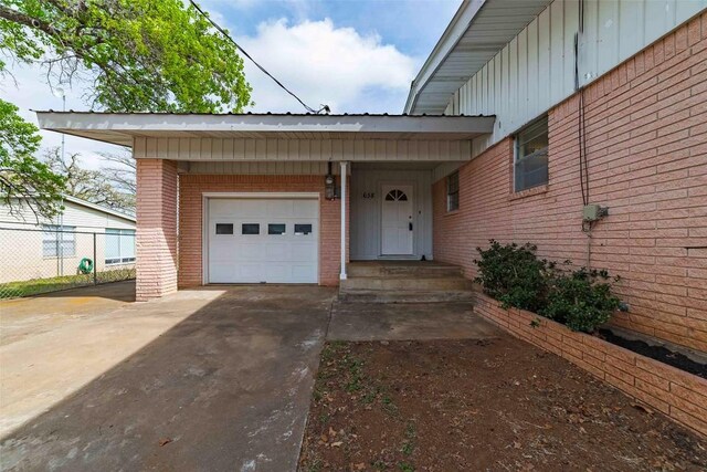 658 Golden Beach Dr, Buchanan Dam, TX 78609 - entrance to property with brick siding, concrete driveway, a garage, and fence