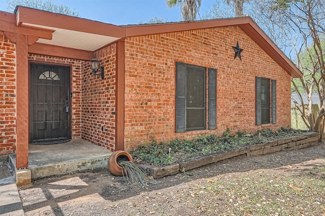 3108 Matador Dr, Austin, TX 78741 - doorway to property featuring brick siding
