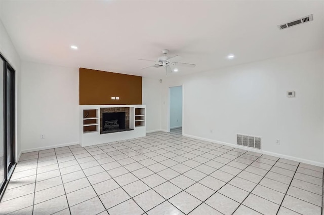 3108 Matador Dr, Austin, TX 78741 - unfurnished living room with baseboards, ceiling fan, built in shelves, and visible vents