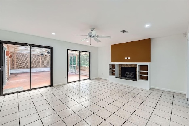 3108 Matador Dr, Austin, TX 78741 - unfurnished living room with light tile patterned floors, baseboards, ceiling fan, and visible vents