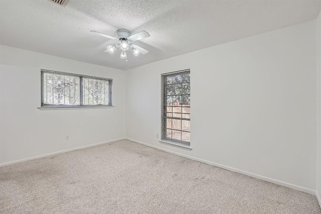 3108 Matador Dr, Austin, TX 78741 - unfurnished room with baseboards, a textured ceiling, carpet, and ceiling fan