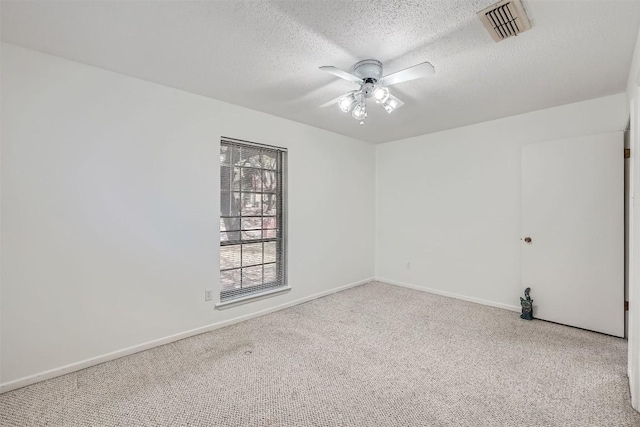 3108 Matador Dr, Austin, TX 78741 - empty room with visible vents, carpet flooring, a textured ceiling, and a ceiling fan