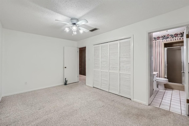3108 Matador Dr, Austin, TX 78741 - unfurnished bedroom featuring ensuite bath, a textured ceiling, carpet, baseboards, and a closet
