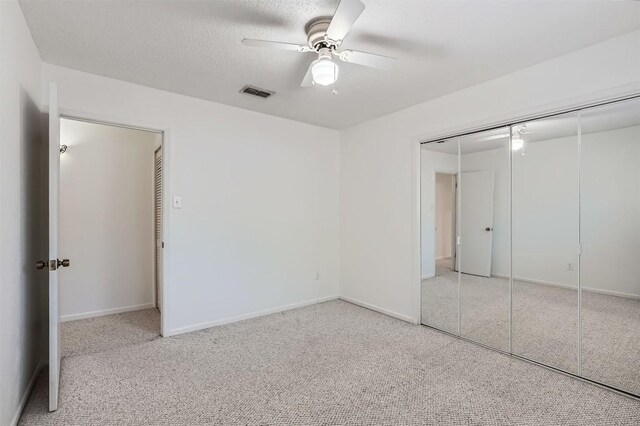 3108 Matador Dr, Austin, TX 78741 - unfurnished bedroom featuring visible vents, a closet, baseboards, a ceiling fan, and carpet