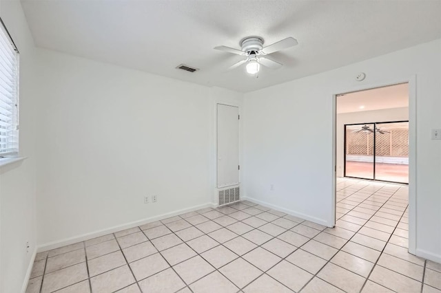 3108 Matador Dr, Austin, TX 78741 - unfurnished room featuring visible vents, baseboards, ceiling fan, and light tile patterned floors