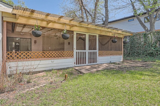 3108 Matador Dr, Austin, TX 78741 - rear view of property with a lawn and a sunroom