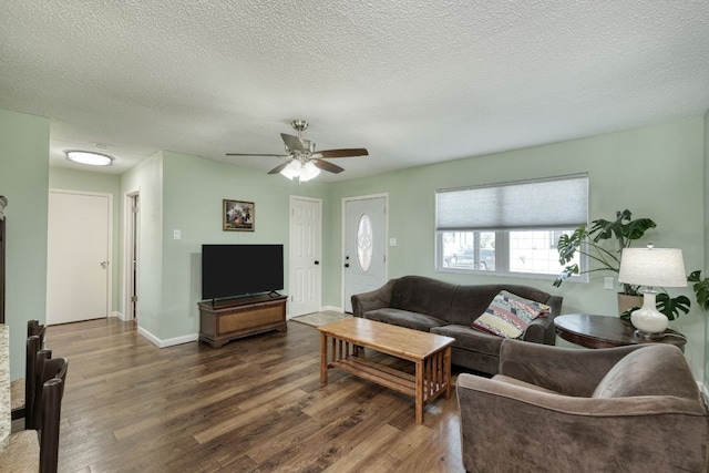 818 Kimbro St, Taylor, TX 76574 - living room with wood finished floors, a ceiling fan, a textured ceiling, and baseboards