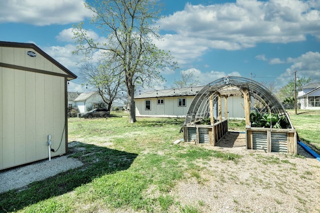 818 Kimbro St, Taylor, TX 76574 - view of green lawn with a vegetable garden