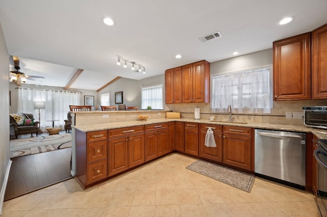 20807 Boggy Ford Rd, Lago Vista, TX 78645 - kitchen featuring stainless steel dishwasher, a peninsula, brown cabinets, light stone countertops, and open floor plan