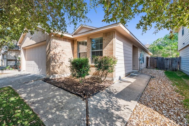 132 Grazing Horse Ln, Manchaca, TX 78652 - single story home featuring a garage, fence, brick siding, and concrete driveway