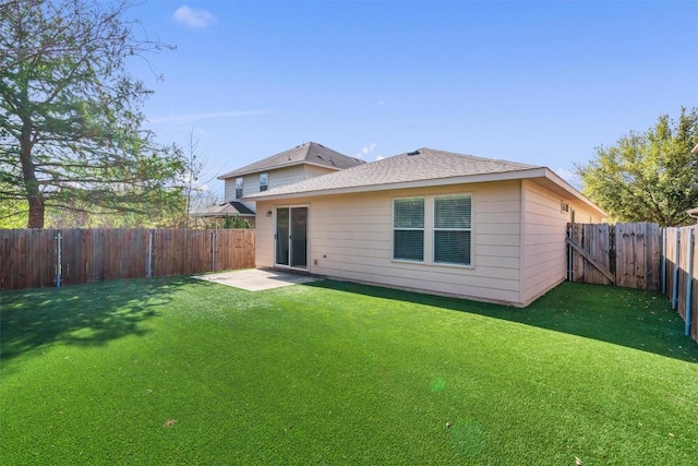 132 Grazing Horse Ln, Manchaca, TX 78652 - back of house featuring a lawn, a shingled roof, a fenced backyard, and a patio