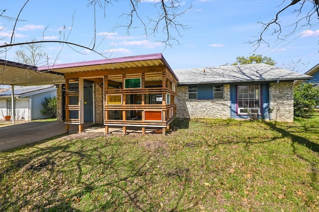 100 E Lisa Dr, Austin, TX 78752 - view of front of house with stone siding and a front yard