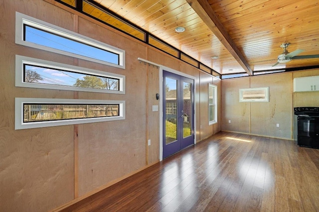 100 E Lisa Dr, Austin, TX 78752 - unfurnished living room with french doors, hardwood / wood-style floors, ceiling fan, and a wood ceiling with exposed beams