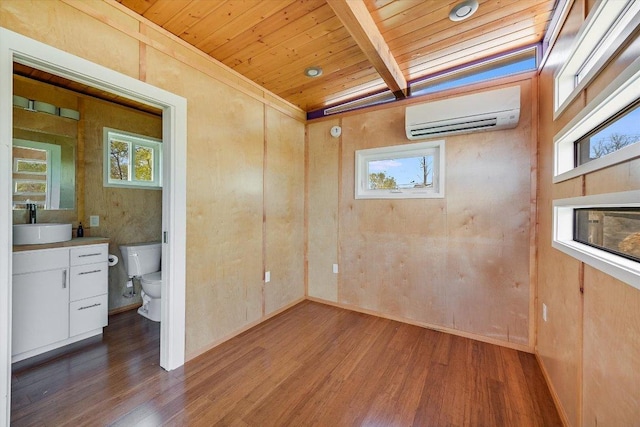 100 E Lisa Dr, Austin, TX 78752 - unfurnished bedroom with a wall unit AC, a wood ceiling with exposed beams, wood finished floors, and multiple windows