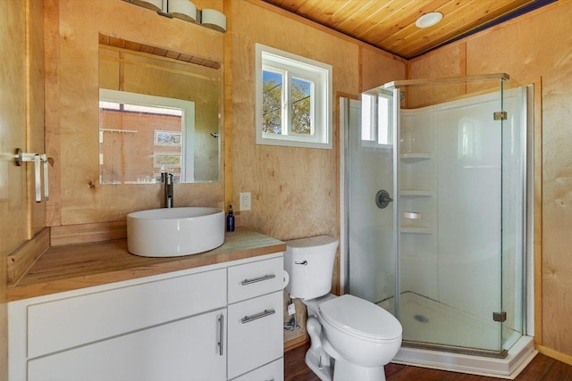100 E Lisa Dr, Austin, TX 78752 - bathroom featuring wood ceiling, vanity, a stall shower, and wood finished floors