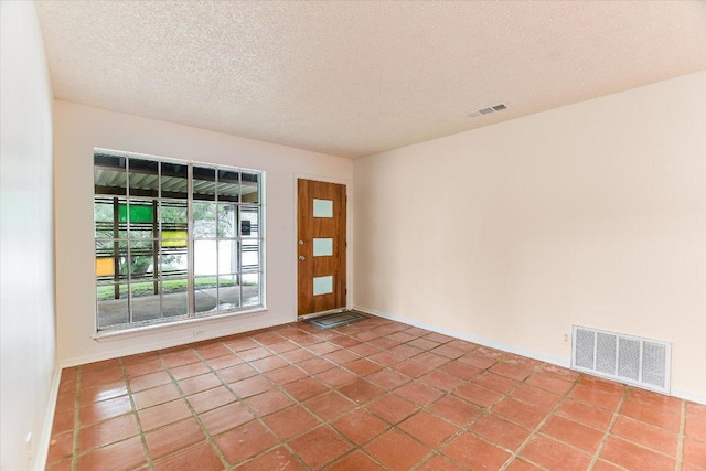 100 E Lisa Dr, Austin, TX 78752 - unfurnished room with a textured ceiling and tile patterned flooring