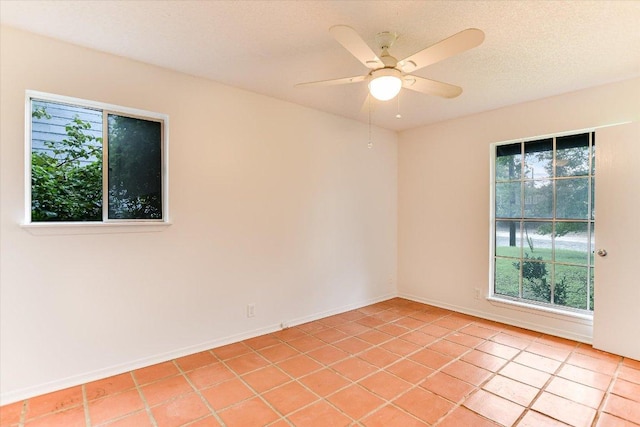 100 E Lisa Dr, Austin, TX 78752 - empty room with a ceiling fan and light tile patterned floors