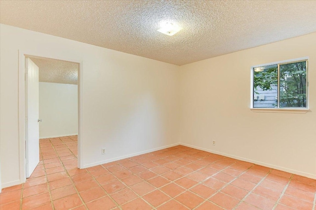100 E Lisa Dr, Austin, TX 78752 - empty room featuring a textured ceiling and light tile patterned floors