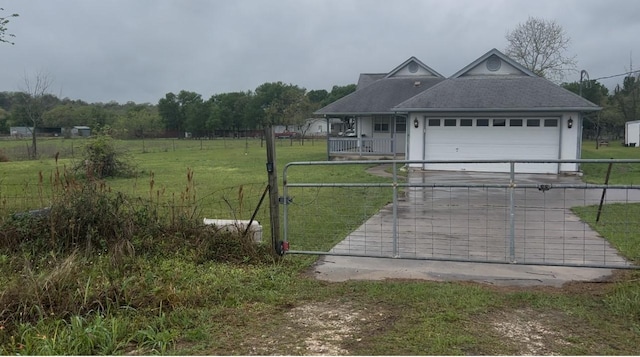 182 Lake Front Dr, Cedar Creek, TX 78612 - view of front of property featuring concrete driveway, a garage, a gate, roof with shingles, and covered porch