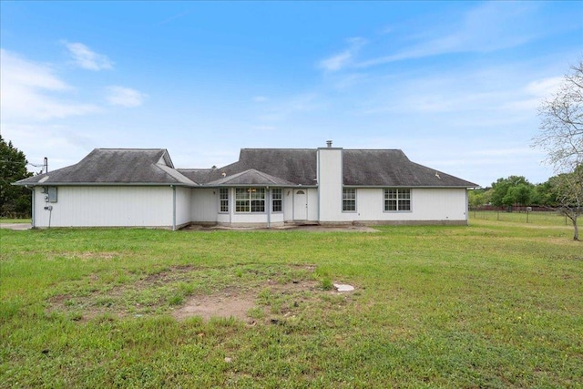 182 Lake Front Dr, Cedar Creek, TX 78612 - rear view of house with a chimney and a yard