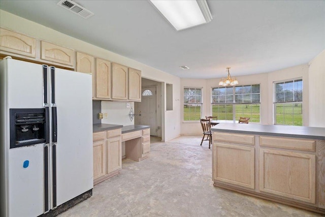 182 Lake Front Dr, Cedar Creek, TX 78612 - kitchen with white fridge with ice dispenser, light brown cabinetry, concrete flooring, a chandelier, and dark countertops