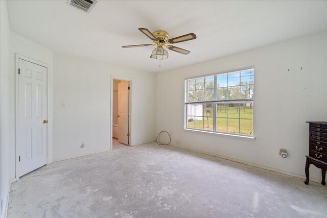 182 Lake Front Dr, Cedar Creek, TX 78612 - unfurnished bedroom with concrete floors, ensuite bathroom, and ceiling fan