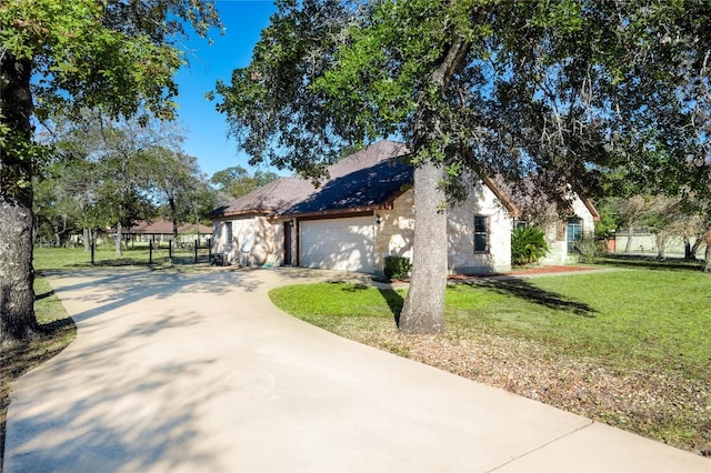 455 Rose Blossom Loop, La Vernia, TX 78121 - view of front of home with a front lawn, driveway, an attached garage, and stone siding