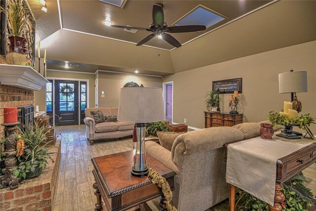 2921 Olympia Dr, Temple, TX 76502 - living area featuring hardwood / wood-style floors, ceiling fan, vaulted ceiling, and a fireplace