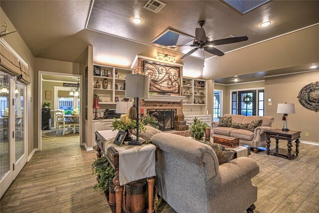 2921 Olympia Dr, Temple, TX 76502 - living area featuring a ceiling fan, hardwood / wood-style flooring, a fireplace, and visible vents