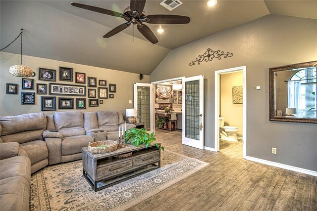 2921 Olympia Dr, Temple, TX 76502 - living room with lofted ceiling, baseboards, ceiling fan, visible vents, and wood finished floors