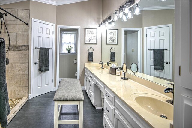 2921 Olympia Dr, Temple, TX 76502 - full bathroom with ornamental molding, a sink, and a tile shower