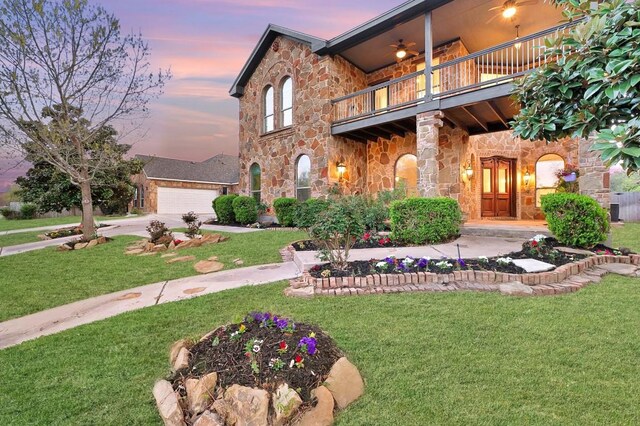 740 Nelson Ranch Rd, Cedar Park, TX 78613 - view of front of home featuring a balcony, stone siding, a lawn, driveway, and a garage