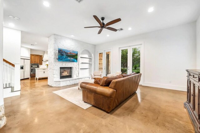 740 Nelson Ranch Rd, Cedar Park, TX 78613 - living area featuring a stone fireplace, built in features, recessed lighting, a ceiling fan, and finished concrete flooring