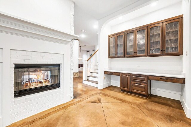 740 Nelson Ranch Rd, Cedar Park, TX 78613 - bar with built in study area, a brick fireplace, stairs, recessed lighting, and concrete flooring