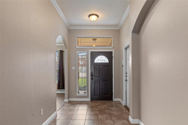 1628 Hidden Springs Path, Round Rock, TX 78665 - entryway with arched walkways, ornamental molding, tile patterned flooring, baseboards, and a textured wall