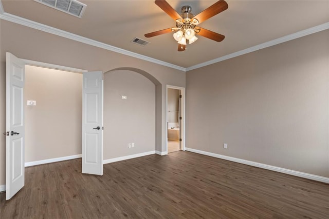 1628 Hidden Springs Path, Round Rock, TX 78665 - empty room with arched walkways, dark wood-style floors, crown molding, baseboards, and a ceiling fan