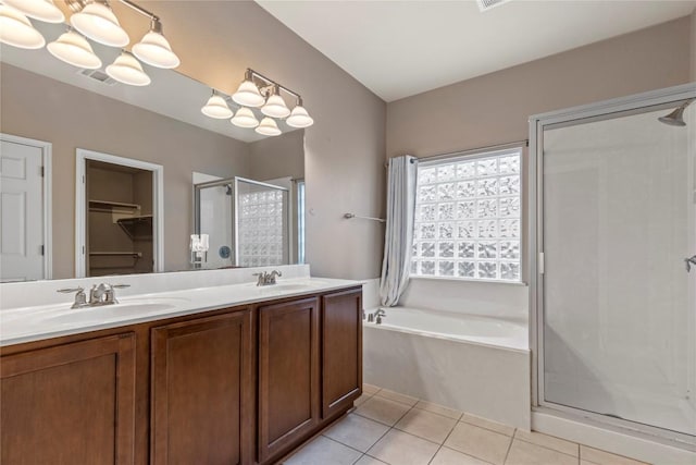 1628 Hidden Springs Path, Round Rock, TX 78665 - bathroom with a shower stall, a chandelier, a bath, double vanity, and tile patterned flooring