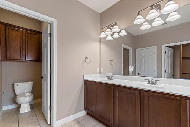 1628 Hidden Springs Path, Round Rock, TX 78665 - full bath with double vanity, tile patterned floors, toilet, a chandelier, and baseboards