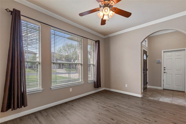 1628 Hidden Springs Path, Round Rock, TX 78665 - unfurnished room with arched walkways, wood finished floors, healthy amount of natural light, crown molding, and baseboards