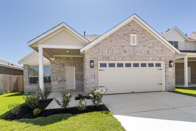 18309 Emu Ln, Manor, TX 78653 - view of front of home with an attached garage, concrete driveway, brick siding, and a shingled roof