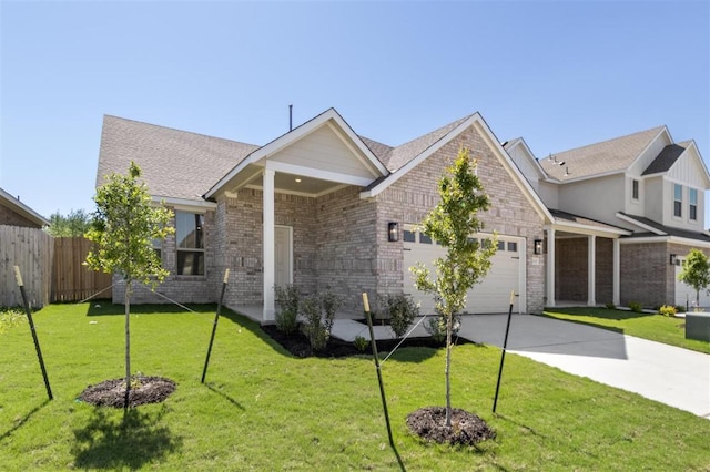 18309 Emu Ln, Manor, TX 78653 - view of front of home with an attached garage, concrete driveway, and brick siding