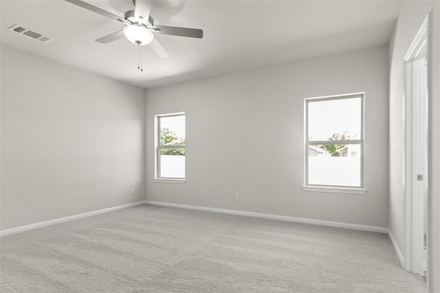18309 Emu Ln, Manor, TX 78653 - empty room featuring light carpet, a ceiling fan, and baseboards